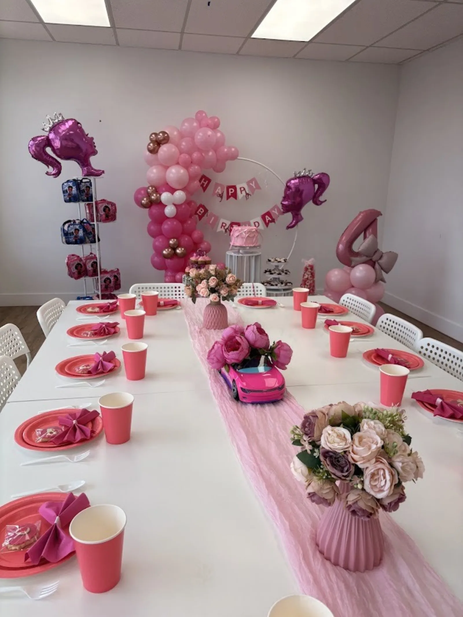 Pink themed birthday party table setup with balloons and decorations at Fun Factory