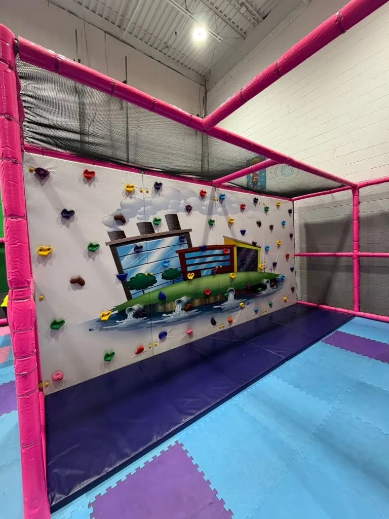 Elevated play bridge with safety netting at Fun Factory
