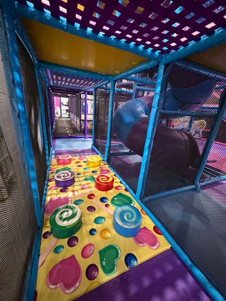 Indoor obstacle course with rainbow padded columns at Fun Factory
